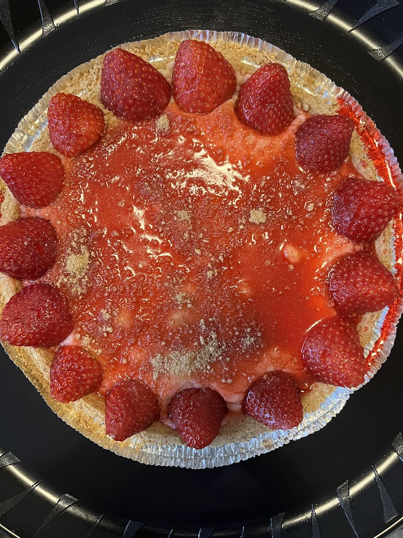Fresh strawberry cheesecake pie with whole strawberries and glaze