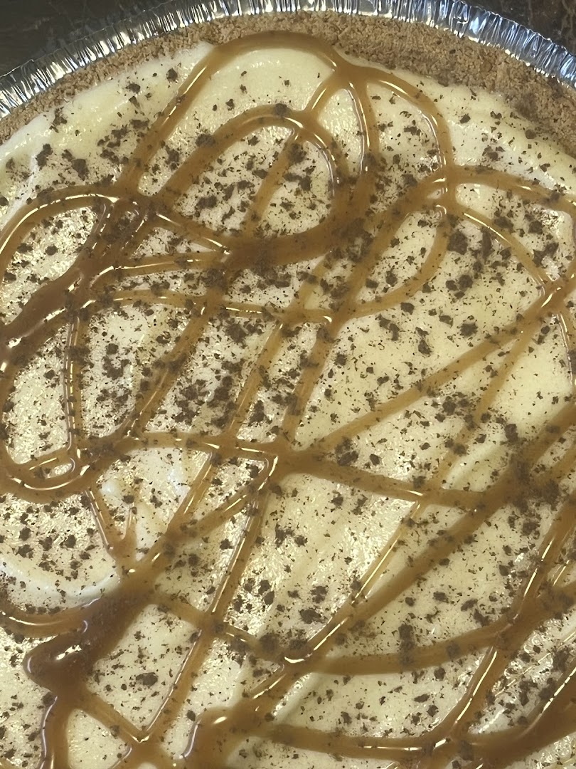 Banana pudding pie with caramel drizzle and chocolate cookie crumble